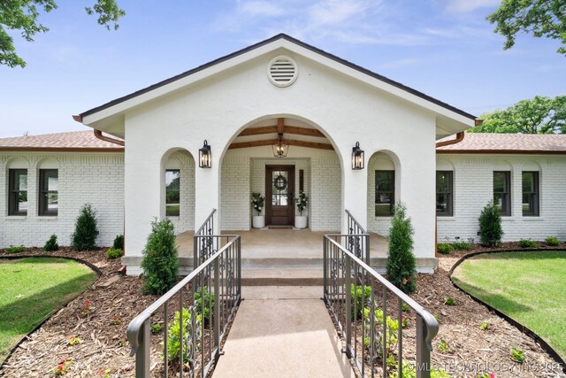 1402 E 125th St S, Jenks, OK 74037 - view of front of home featuring brick siding, a porch, and roof with shingles