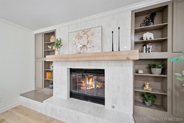 1402 E 125th St S, Jenks, OK 74037 - detailed view of crown molding, a glass covered fireplace, baseboards, built in features, and wood finished floors