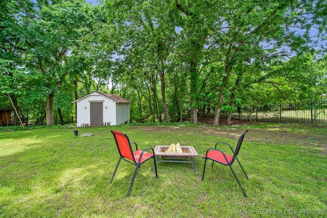 1402 E 125th St S, Jenks, OK 74037 - view of yard featuring a fire pit, a storage unit, an outdoor structure, and view of wooded area