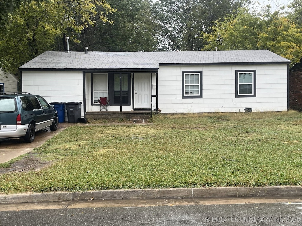 3149 N Hartford Ave, Tulsa, OK 74106 - ranch-style house with a front yard, a garage, a porch, and concrete driveway