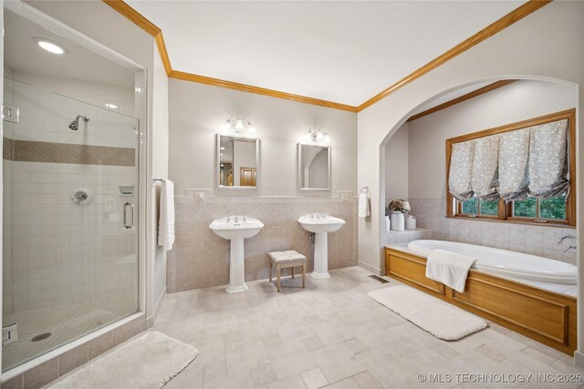 5263 Oak Leaf Dr, Tulsa, OK 74131 - full bath featuring tile walls, a stall shower, a bath, crown molding, and wainscoting