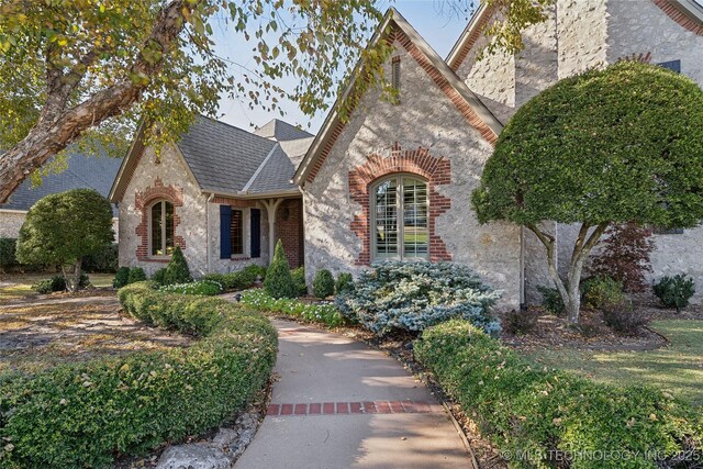 5263 Oak Leaf Dr, Tulsa, OK 74131 - tudor home with brick siding and a shingled roof