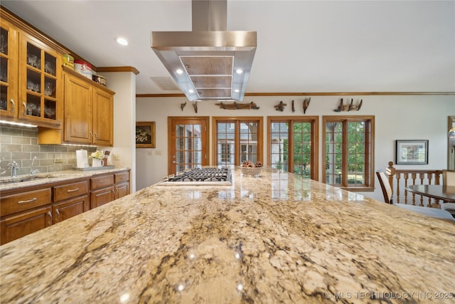 5263 Oak Leaf Dr, Tulsa, OK 74131 - kitchen featuring crown molding, island exhaust hood, a sink, light stone countertops, and brown cabinetry