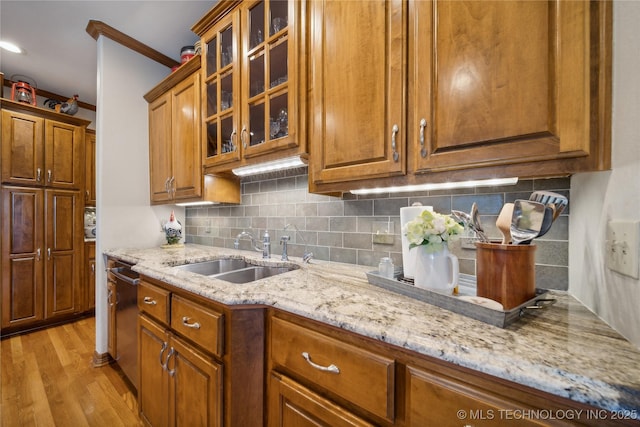 5263 Oak Leaf Dr, Tulsa, OK 74131 - kitchen featuring a sink, light stone countertops, light wood-type flooring, dishwasher, and brown cabinets