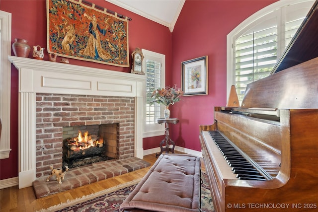 5263 Oak Leaf Dr, Tulsa, OK 74131 - sitting room with crown molding, wood finished floors, a brick fireplace, and baseboards