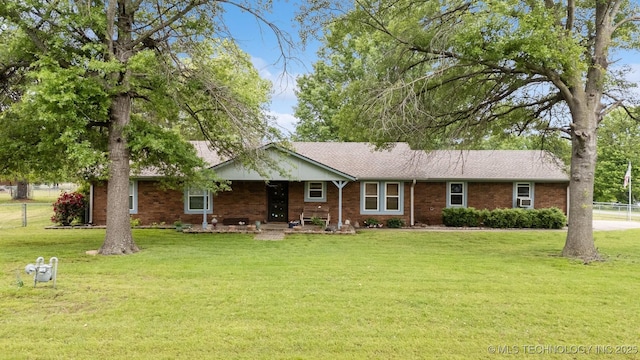 single story home featuring covered porch, brick siding, and a shingled roof