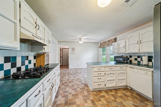kitchen with white dishwasher, a peninsula, black gas stovetop, backsplash, and under cabinet range hood