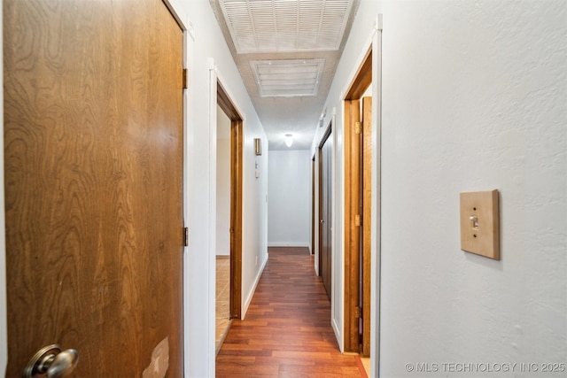 hallway with wood finished floors and baseboards