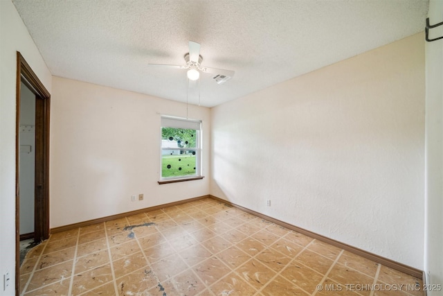 unfurnished bedroom featuring a textured ceiling, baseboards, and ceiling fan