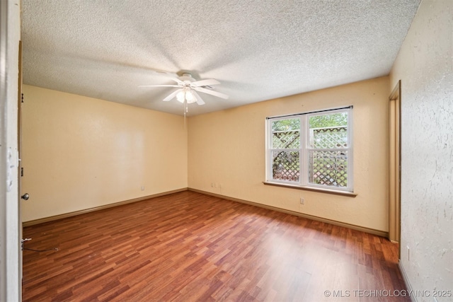 empty room featuring wood finished floors, ceiling fan, a textured ceiling, and baseboards
