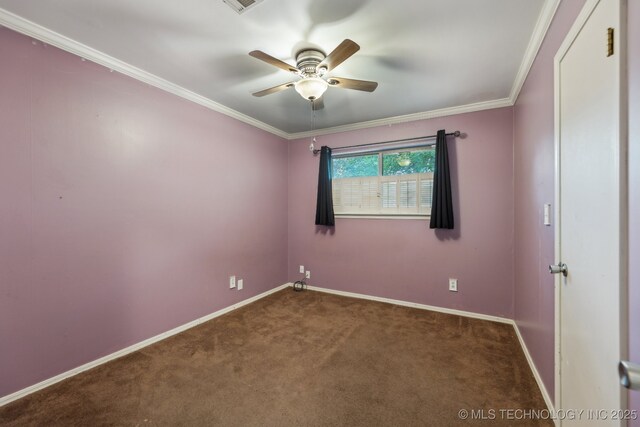 spare room featuring carpet floors, baseboards, a ceiling fan, and crown molding