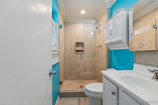 full bathroom with a shower stall, toilet, vanity, and crown molding