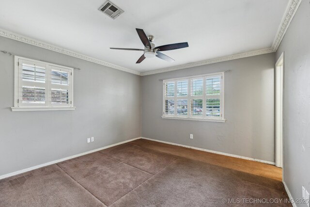 carpeted spare room featuring ceiling fan, ornamental molding, and baseboards
