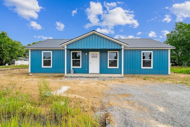 112 E Loy Ave, Chouteau, OK 74337 - view of front facade featuring a porch, a metal roof, and board and batten siding