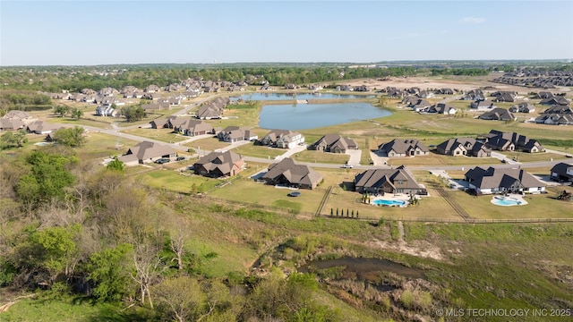aerial view of property's location featuring nearby suburban area and a large body of water