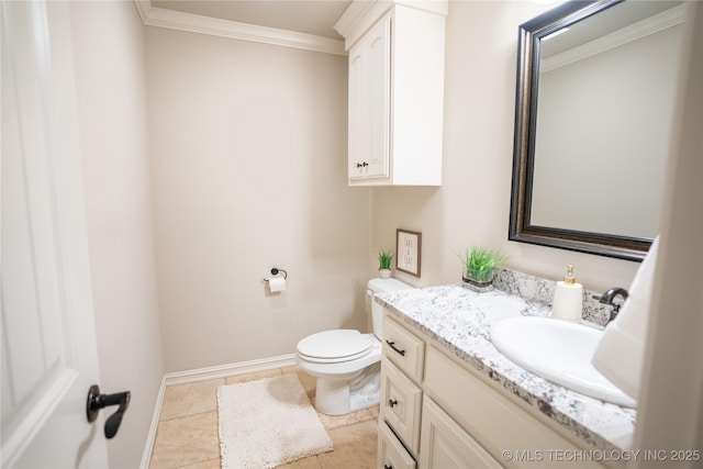 bathroom with crown molding, toilet, vanity, tile patterned flooring, and baseboards