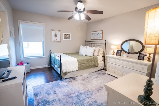 bedroom with wood finished floors, baseboards, and ceiling fan
