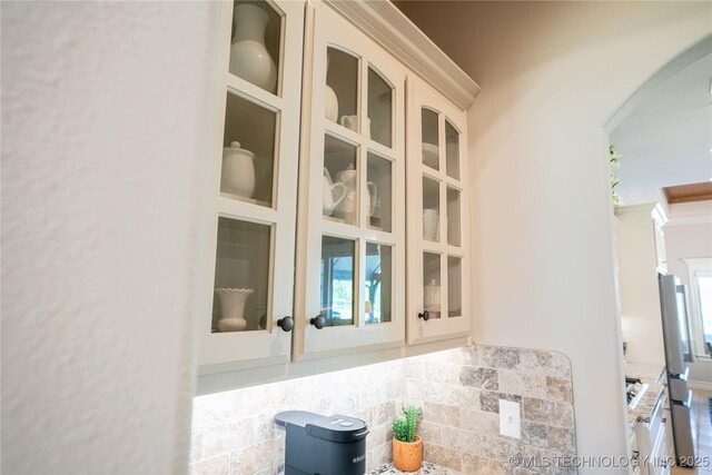 8342 N 149th E Ave, Owasso, OK 74055 - detailed view of stucco siding, arched walkways, and glass insert cabinets