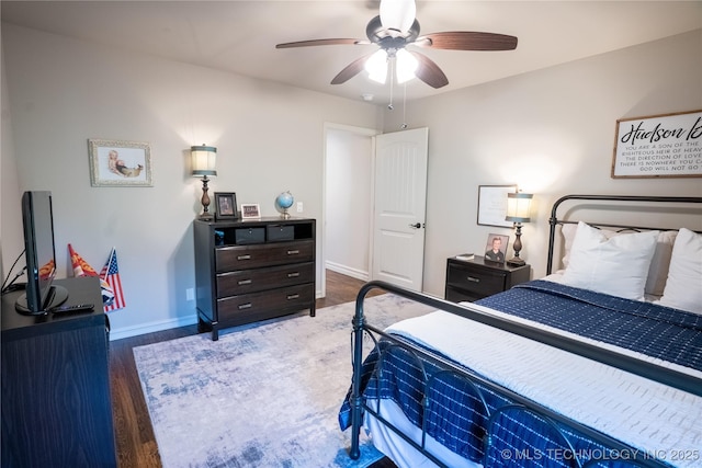 bedroom with baseboards, wood finished floors, and ceiling fan