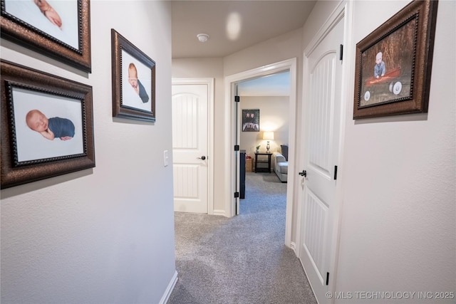 hall featuring carpet floors and baseboards