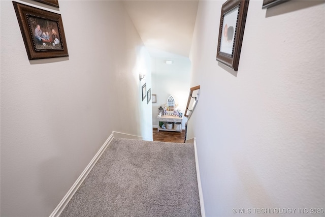hallway with carpet and baseboards
