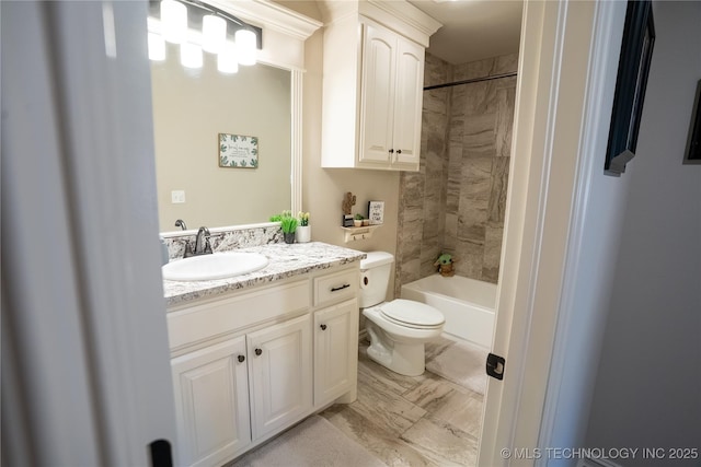 full bath featuring toilet, vanity, marble look tile flooring, and shower / washtub combination