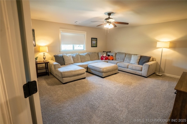 living area with carpet flooring, a ceiling fan, and baseboards