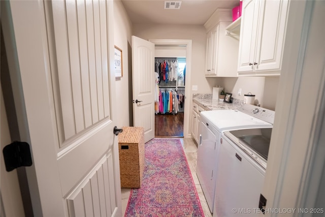 laundry room featuring cabinet space and washing machine and dryer