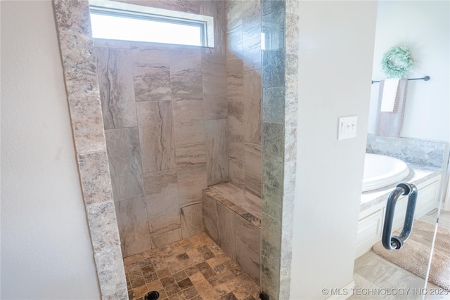 bathroom featuring a tile shower