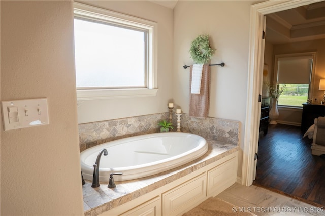 bathroom featuring a bath and crown molding