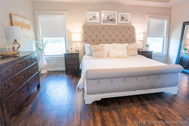 bedroom featuring dark wood-style floors and baseboards