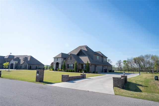 view of front of property featuring curved driveway and a garage