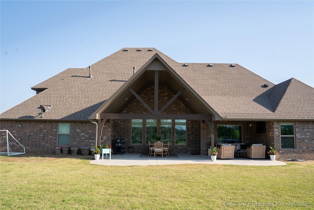 rear view of house featuring a patio, brick siding, and a lawn
