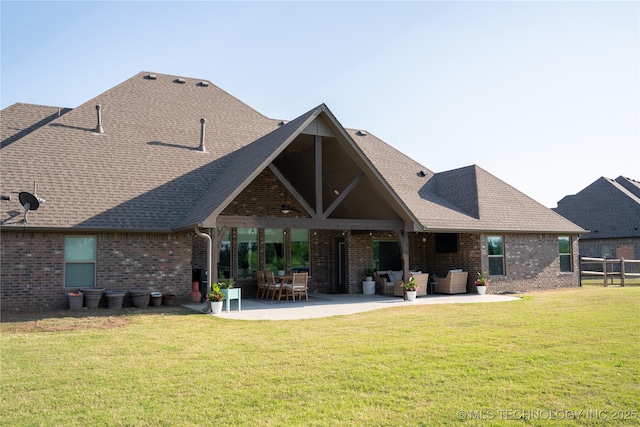 rear view of property featuring outdoor lounge area, brick siding, ceiling fan, a patio area, and roof with shingles