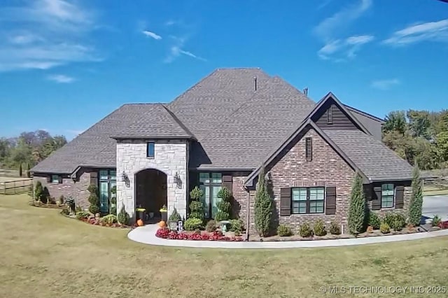 8342 N 149th E Ave, Owasso, OK 74055 - view of front of house with stone siding, a front yard, and a shingled roof