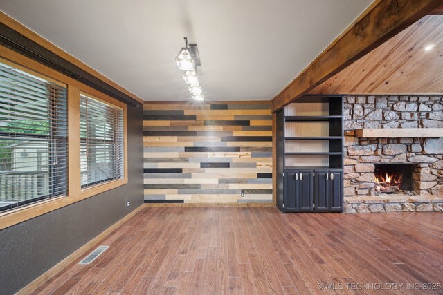 1405 W Huntsville St, Broken Arrow, OK 74011 - unfurnished living room with wood-type flooring and a stone fireplace