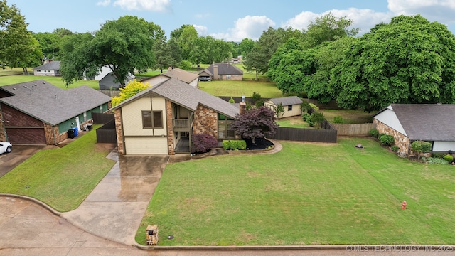 view of front of property with brick siding, concrete driveway, an attached garage, a balcony, and a residential view