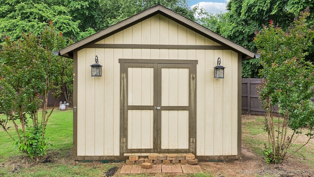 view of shed featuring fence