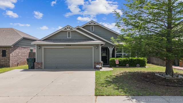 craftsman house with driveway, a garage, and brick siding