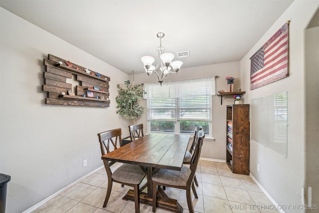 dining space featuring a chandelier, light tile patterned floors, and baseboards