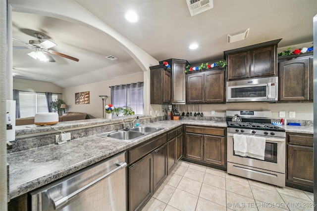 kitchen with appliances with stainless steel finishes, a sink, a ceiling fan, light tile patterned flooring, and dark brown cabinets