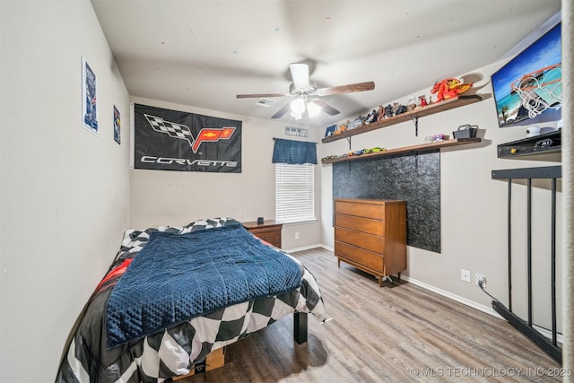 bedroom with wood finished floors, baseboards, and ceiling fan