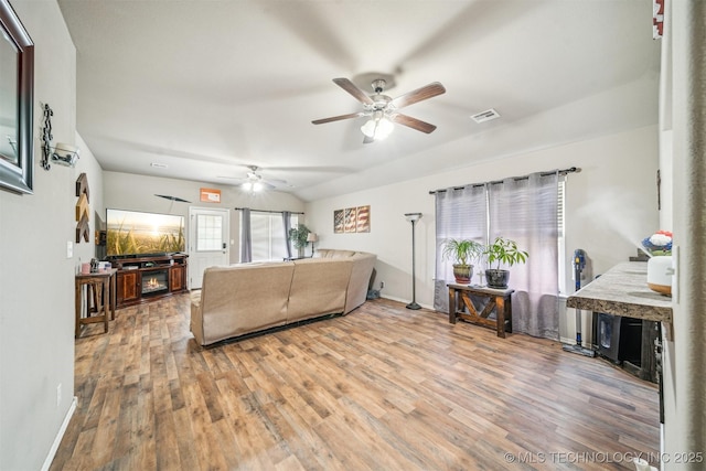 living area with ceiling fan, wood finished floors, and baseboards