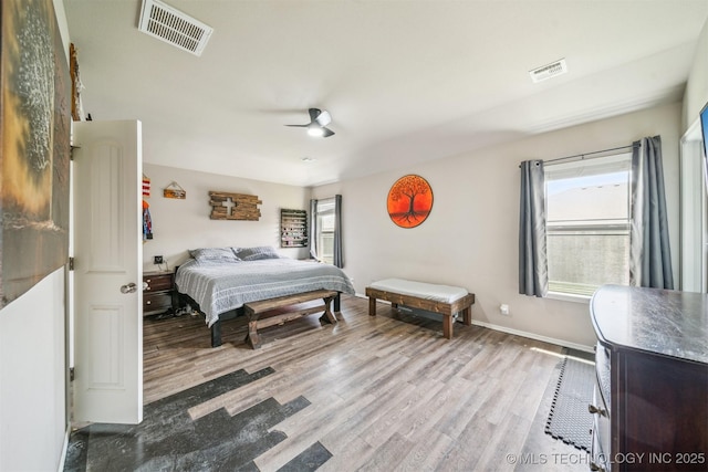 bedroom featuring wood finished floors, ceiling fan, and baseboards