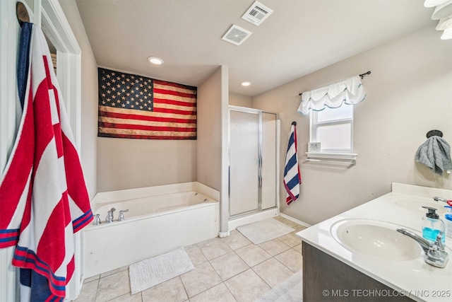 full bathroom featuring tile patterned floors, a bath, a stall shower, recessed lighting, and double vanity