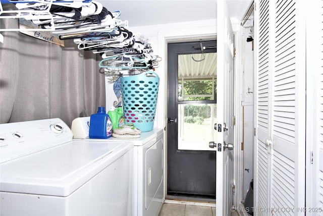 laundry area featuring separate washer and dryer and light tile patterned flooring