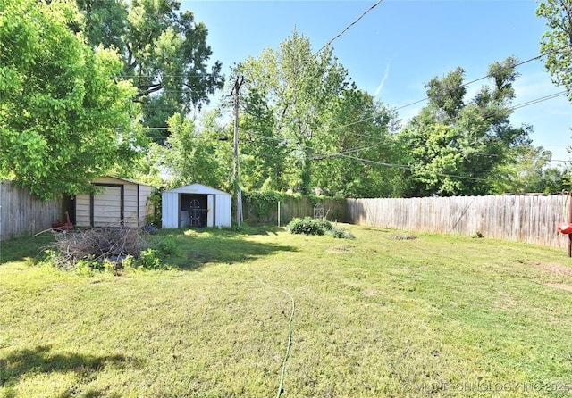 view of yard featuring a shed and an outbuilding