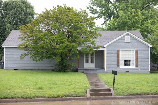 view of front of home with roof with shingles, a front yard, crawl space, french doors, and a porch