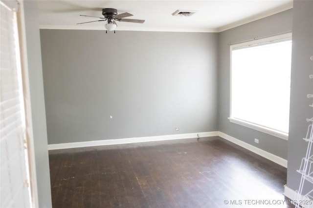 empty room with dark wood-style floors, ornamental molding, ceiling fan, and baseboards