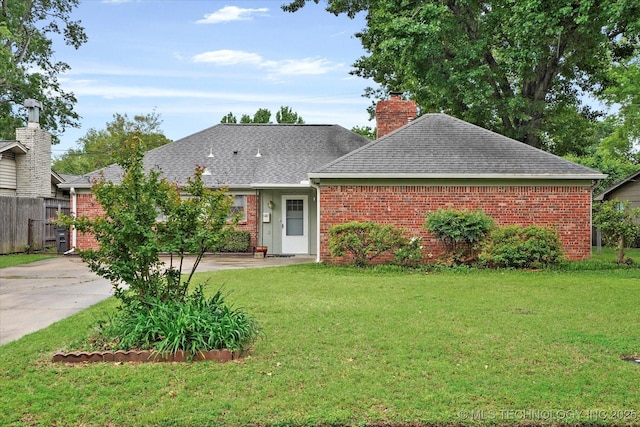 ranch-style home with brick siding, a shingled roof, and a chimney